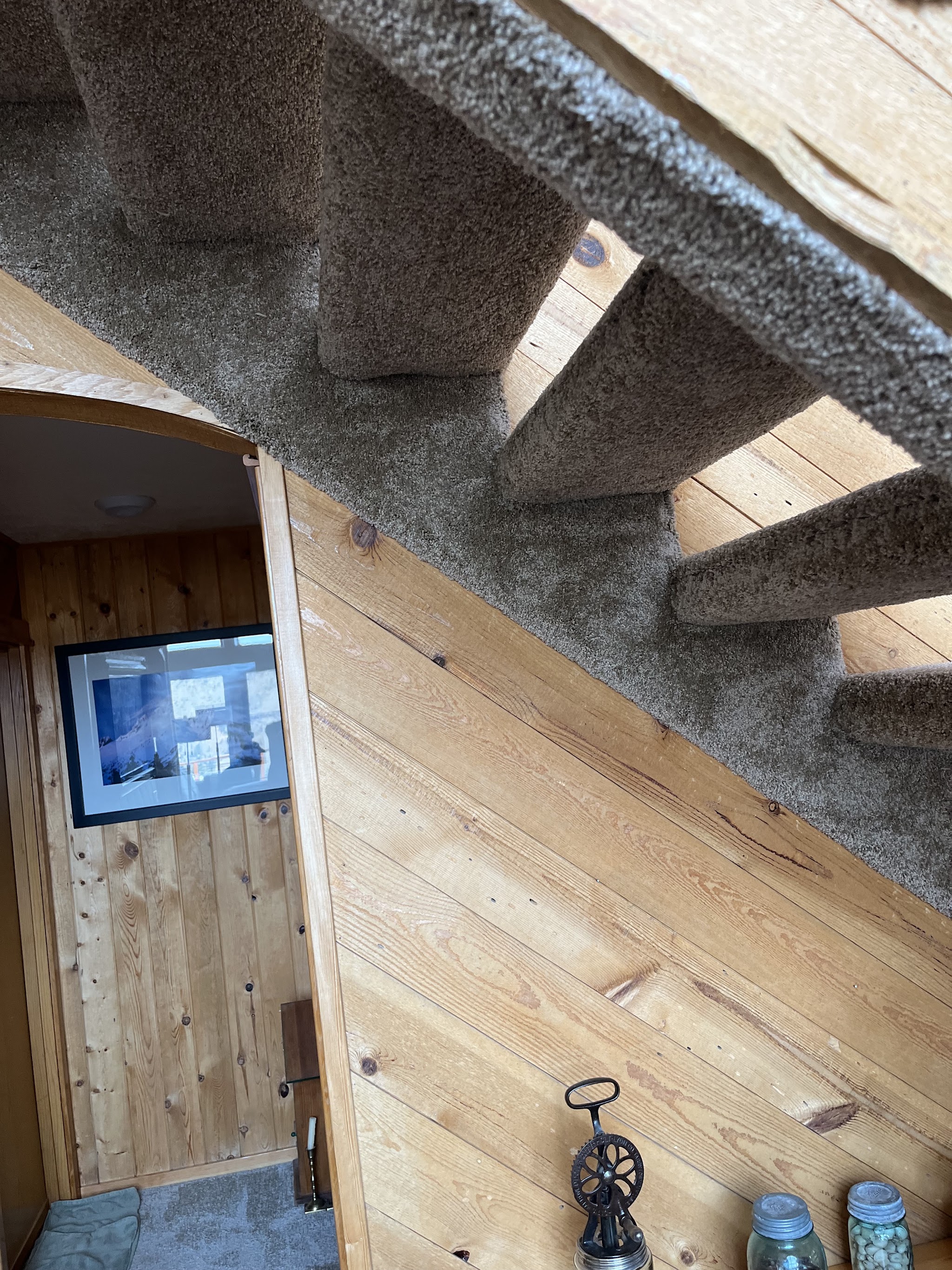 A cabin staircase with new carpet-wrapped treads