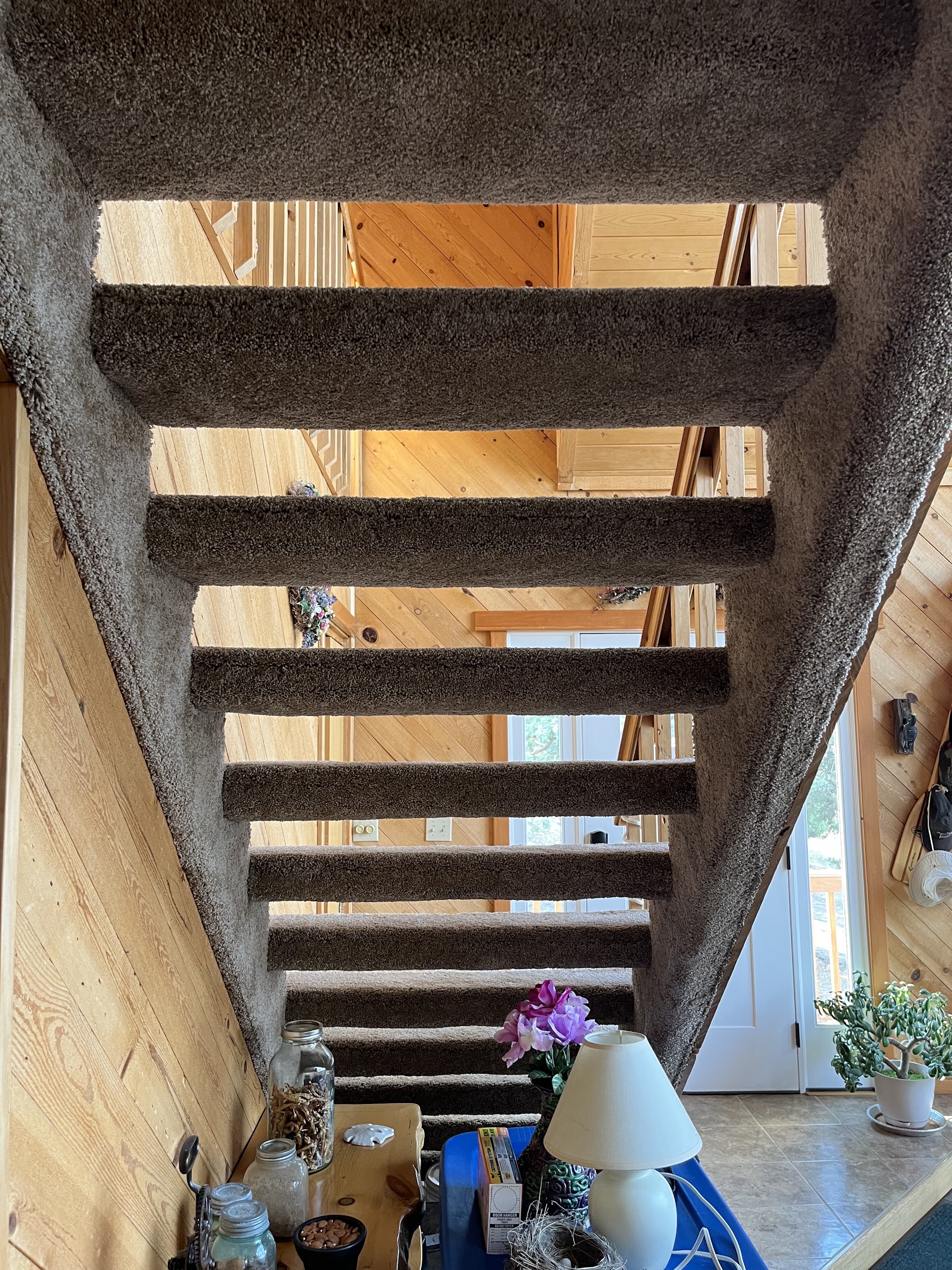 A wide view of a finished cabin staircase with carpet treads